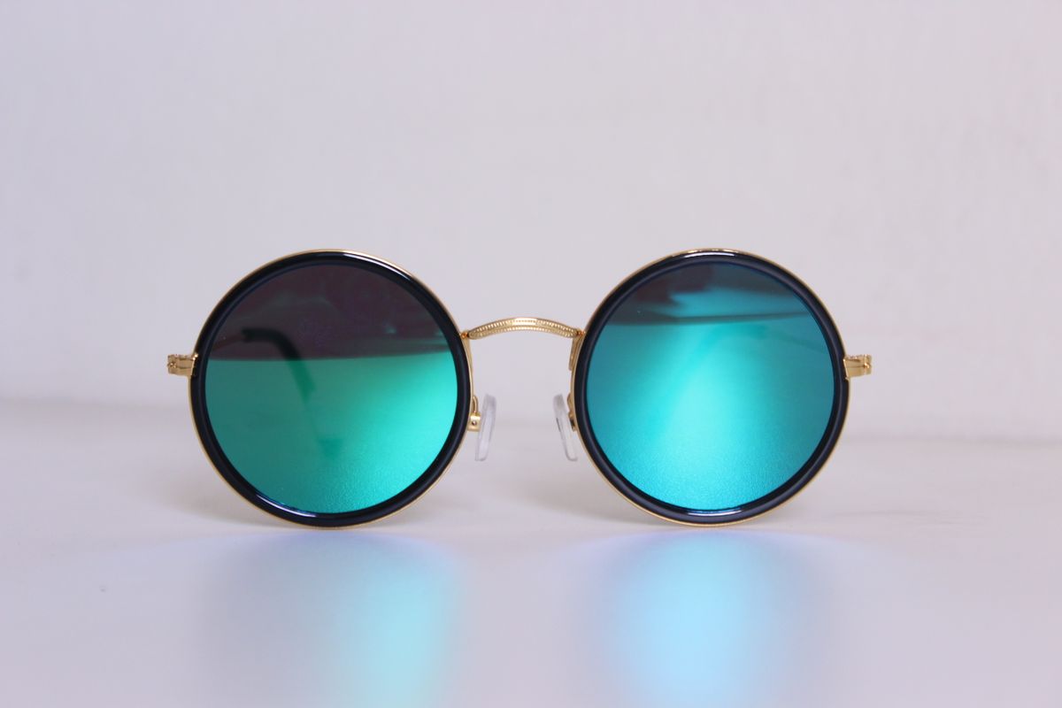 Real round gold-frame sunglasses with turquoise lenses