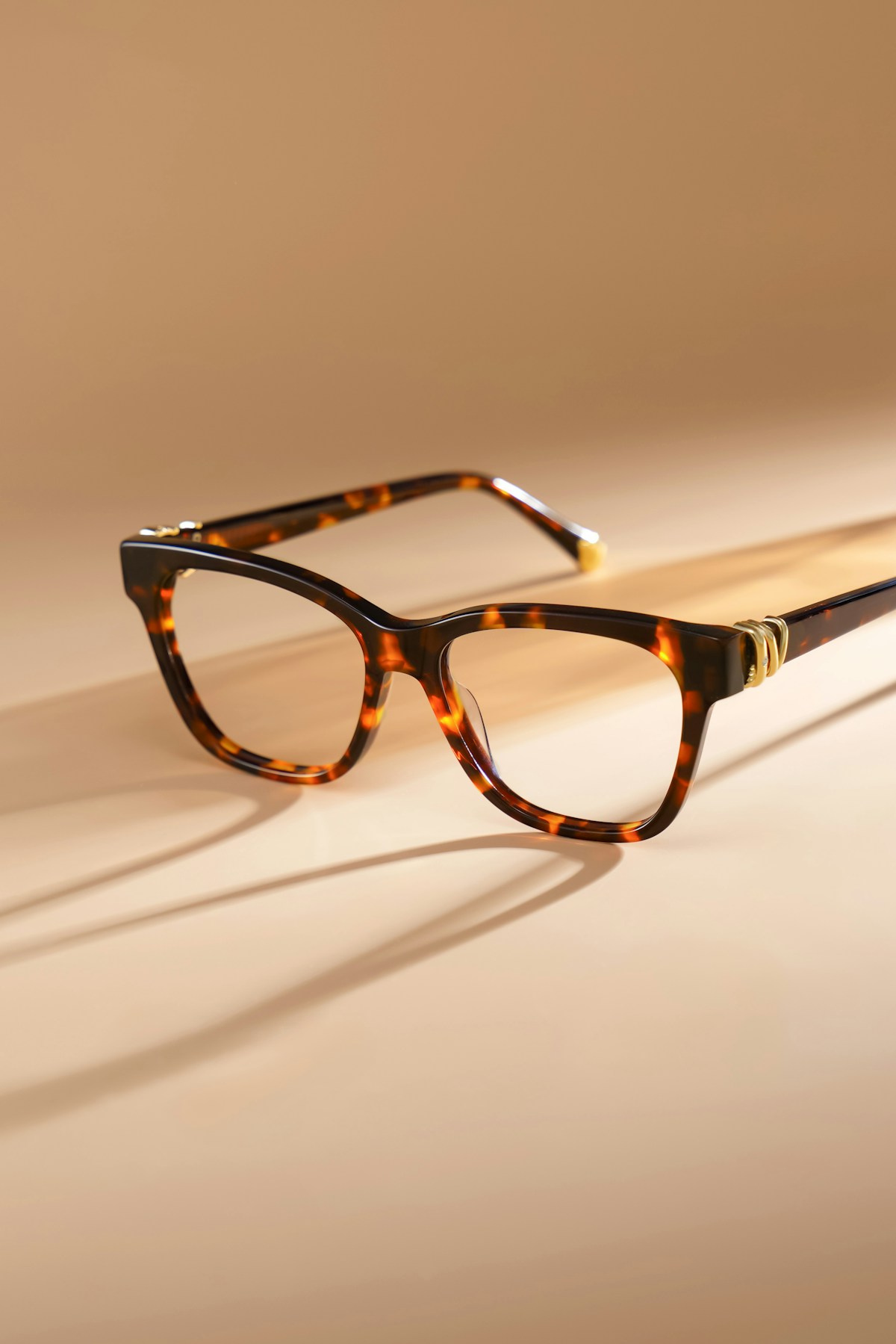 Real tortoiseshell optical frames on a sunlit surface